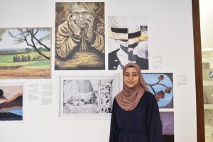 Student Maymana Hasan alongside her works
