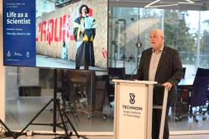 Prof. Uri Sivan speaking at the exhibition opening