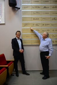 Prof. Feringa (left) with Prof. Apeloig next to signature wall