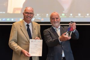 Prof. Charlotte Voght's father receiving the award on her behalf