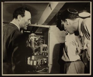 Prof. Franz Ollendorff explains one of the electrical mechanisms to two of his students in a Technion laboratory, 1956.
