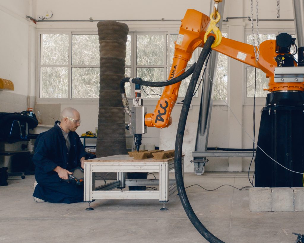 The 3D printing process using a robotic arm (KUKA KR50) at the Technion’s Center for Advanced Manufacturing (TACC). The soil-based mixture is printed to create modular, climate-adapted units.